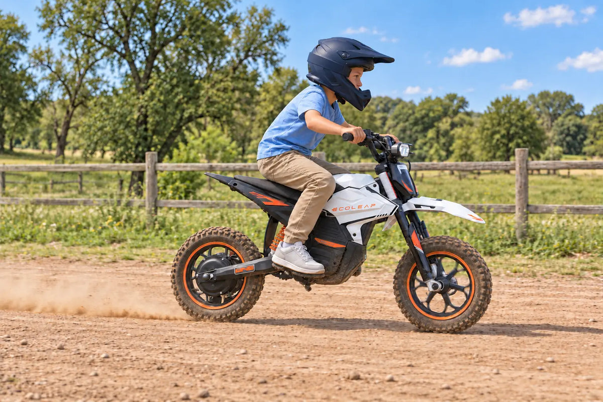 Protected young rider moving across an open dirt track on a white Ecoleap K2 with horizontal panning motion blur