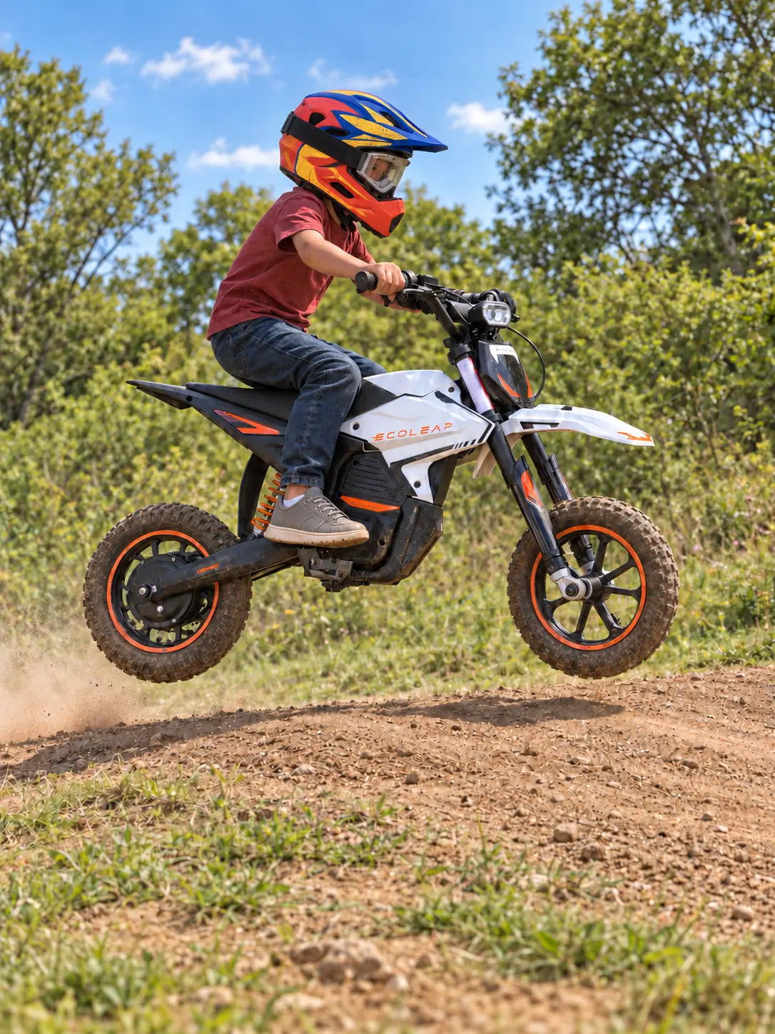 Protected young rider on a white Ecoleap K2 climbing a gentle open dirt hill, viewed low from the rear